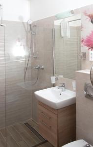 a bathroom with a shower and a sink and a toilet at Relax & Therapy in Bad Tatzmannsdorf