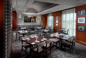 a restaurant with tables and chairs in a room at Omni Providence in Providence
