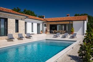 a villa with a swimming pool and patio at Villa Gala by Rent Istria in Kringa