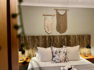 a bedroom with a bed with a wooden headboard at The Boshoff in Durban