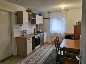 a small kitchen with a table and a stove top oven at delblaiso suite in Memmingen