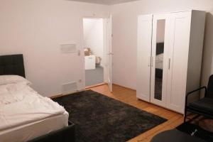 a bedroom with a bed and a door to a room at delblaiso suite in Memmingen