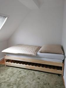 a bed sitting on a wooden platform in a room at delblaiso suite in Memmingen