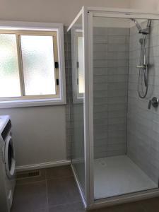 a bathroom with a shower with a glass door at Swanpool - Serendipity House in Swanpool +28 photos