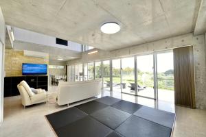 a living room with a couch and chairs and a television at Guest House Karst in Ufudo