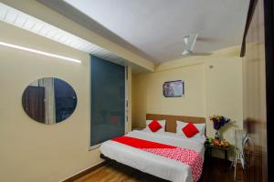 a bedroom with a large bed with red pillows at Super OYOHotel Silver Stay 02 in Jaipur