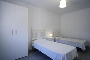 Ένα ή περισσότερα κρεβάτια σε δωμάτιο στο La Perla 2 +1 φωτογραφίες
