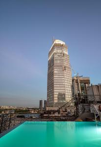 a tall building with a pool in front of it at Icon Saigon - LifeStyle Design Hotel in Ho Chi Minh City