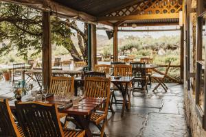 a restaurant with wooden tables and chairs on a patio at Skillogalee Estate in Clare