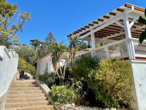 a staircase leading to a house with a wooden pergola at Modern private Suite at fantastic villa near Fuengirola in Mijas