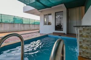 a swimming pool in a house at ll 2BHK ll PRIVATE POOL ll GOOD LUCK VILLA ll FREE BREAKFAST in Lonavala