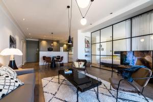 a living room with a couch and a table at BEACHVIEW KEYWEEK Beachfront Renovated Apartment with Parking in Biarritz in Biarritz