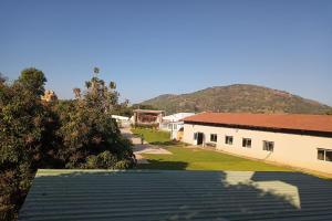 une vue sur un bâtiment avec une montagne en arrière-plan dans l'établissement DMM Resort, à Urdigere