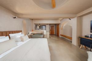 a bedroom with two beds and a tub in it at Roome in Fethiye