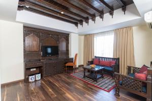 a living room with a couch and a tv at Hotel Shambala in Kathmandu