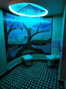 a bathroom with a mural of trees and birds at Residence Des Sources in Amnéville