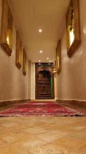 an empty room with a large door and a red rug at Residence Des Sources in Amnéville