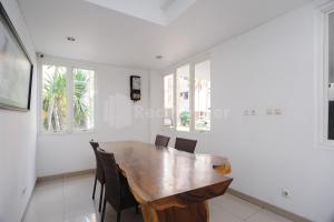 a dining room with a wooden table and chairs at Green Residence 25 Syariah Karawaci RedPartner in Tangerang
