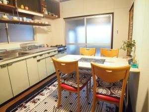 a kitchen with a table with chairs and a sink at Classy Busshozan - Vacation STAY 15858 in Takamatsu