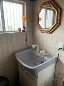 a bathroom with a sink and a mirror at Classy Busshozan - Vacation STAY 15858 in Takamatsu