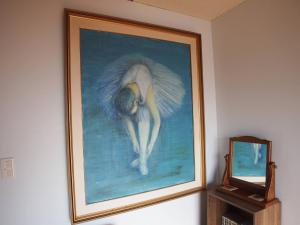 a painting of an angel on a wall next to a mirror at Classy Busshozan - Vacation STAY 15858 in Takamatsu
