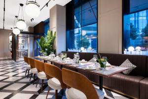 a long dining room with a long table and chairs at Intercity Wuhan Guanshan Avenue in Wuhan
