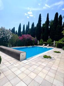 a swimming pool in a garden with trees at Benjamin house in Kaštela