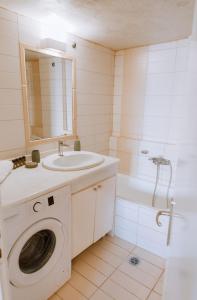 a bathroom with a washing machine and a sink at Central house in Agios Nikolaos