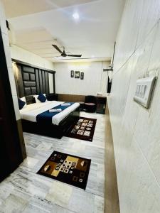 a bedroom with a bed and two rugs in a room at Hotel Sheela, 100m from Taj Mahal in Agra