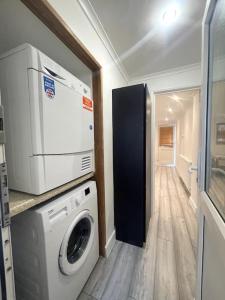 a laundry room with a washing machine and a washer at Adorable 1-bedroom entire place with free parking in Cambridge