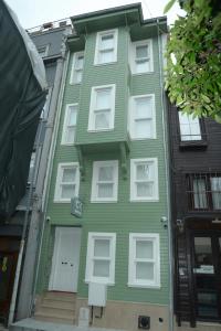 a green house with white windows on a street at CK SULTANAHMET HOTEL in Istanbul