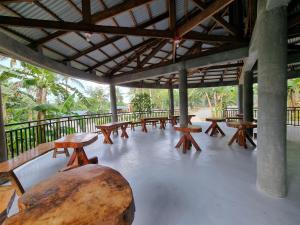 a group of picnic tables and a large log at California Breeze Campsite in Indang