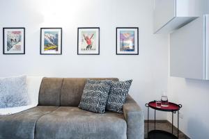 a living room with a couch and some pictures on the wall at Casa dei Ciliegi in Morgex