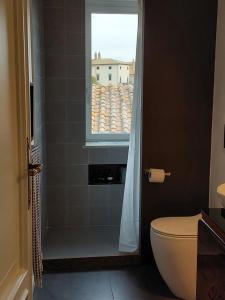 ローマにあるLess is moreのバスルーム(シャワー、トイレ付)、窓が備わります。