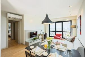 a living room with a dining table and a living room at Fraser Place Antasya Istanbul in Istanbul