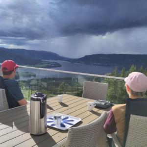 a couple of people sitting at a table on a deck at Granum Gård in Fluberg