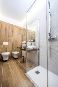 a bathroom with a shower and a toilet and a sink at Corte Ongaro Hotel in Verona