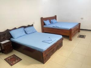A bed or beds in a room at Mystic Manor Stonetown B&B