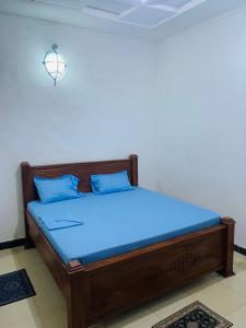 a bed in a room with a blue mattress at Mystic Manor Stonetown B&B in Stone Town