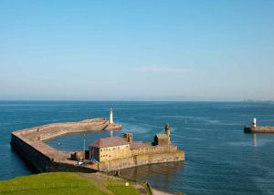 an island in the water with a lighthouse on it at Falcon Garth in Egremont