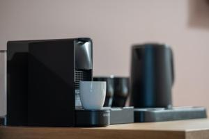 a coffee maker and a cup on a table at Oniro Boutique Hotel in Toroni