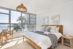 a bedroom with a large bed with a view of the ocean at Welgelegen 608 in Strand
