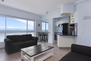 a living room with a couch and a table at Pips Place 301 in Strand