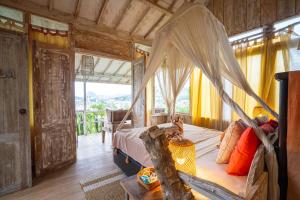 a bedroom with a bed with a canopy at Selini Hills in Labuan Bajo