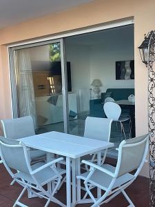 a white table and chairs in a living room at Andrea's holydays in Roquebrune-Cap-Martin