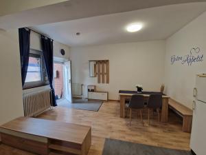 a kitchen and living room with a table and chairs at Gästehaus Zur Post Spickermann in Xanten