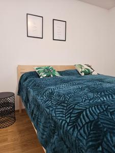 a bedroom with a bed with a blue comforter at HIGH CLASS - Design Apartment - Favorite Place - Full Equipment - Public Transport in Nürnberg