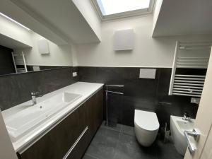 a bathroom with a tub and a toilet and a sink at Charming Apts - Via Pastrengo in Porto Recanati +34 photos