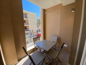 a table and chairs in a room with a balcony at Charming Apts - Via Pastrengo in Porto Recanati