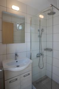 a bathroom with a sink and a shower at Bellino Apartments "Adults Only" in Hersonissos